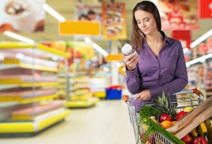 woman checking label for clean foods quality